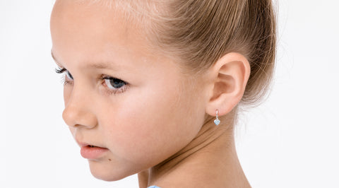 young girl wearing sterling kids earrings from nz