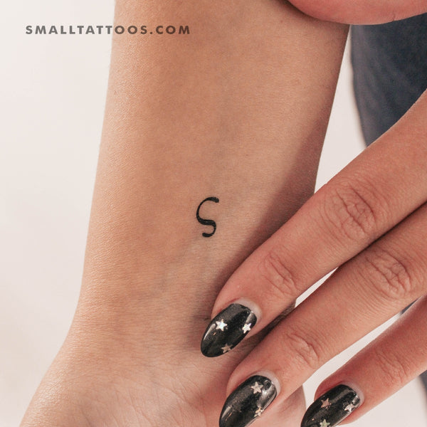 Sigma letter tattoo on the inner arm.