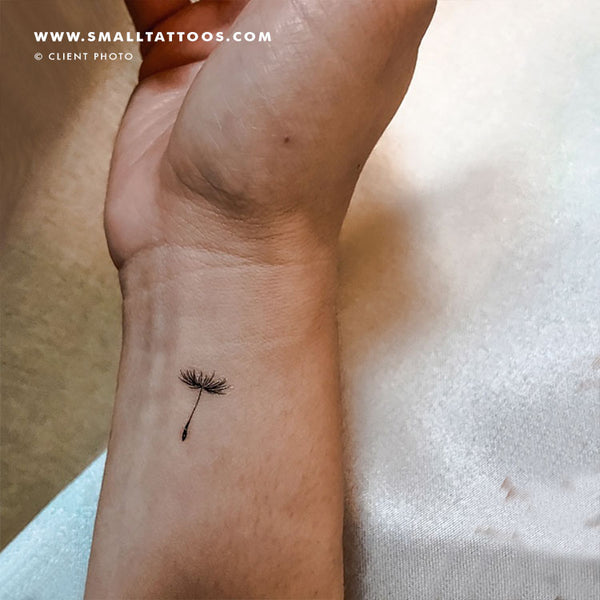 Dandelion seed tattoo located on the upper arm, fine