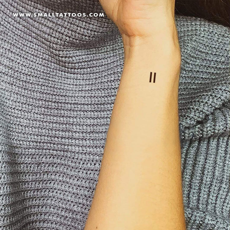 Equal sign tattoo on the left forearm