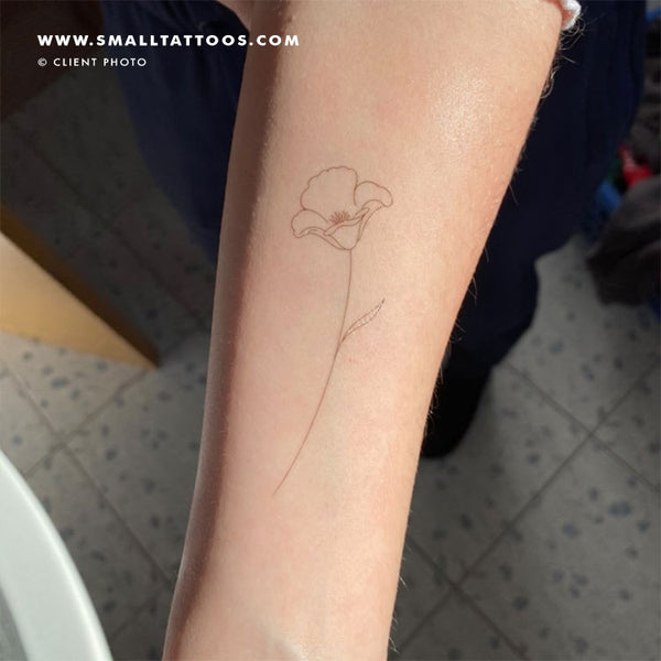 Small poppy tattoo on the left forearm