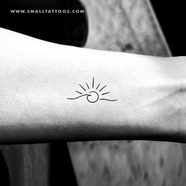 FIne line sea sunset tattoo located on the rib