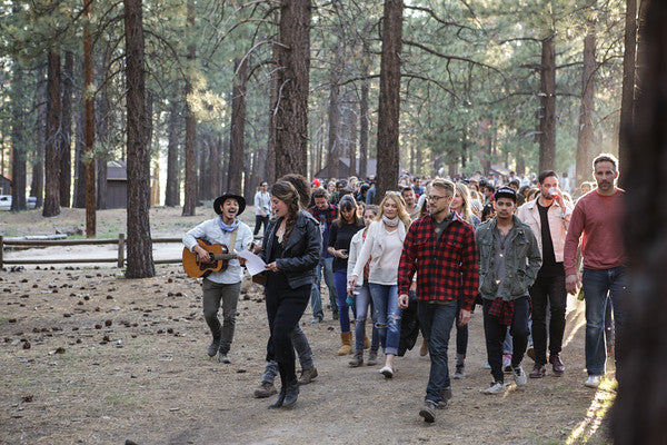Group of pepole walking in the woods.