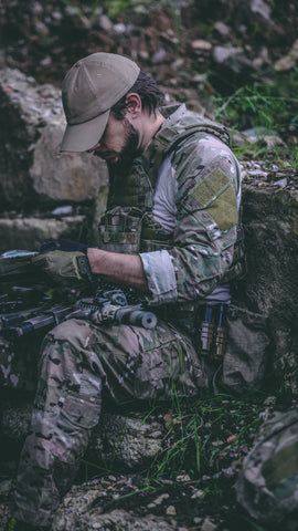 A soldier reading a map wearing multicam