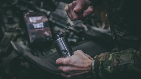 Rhinowares coffee grinder being used by a soldier in camouflage