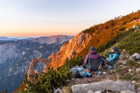 couple sitting on a mountain with amazing view