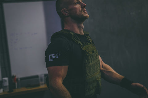 |gallery| man in weighted vest wearing contact coffee co t-shirt