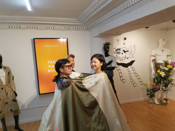 People in "meditation blanket" at Yumi Sakugawa's art exhibition
