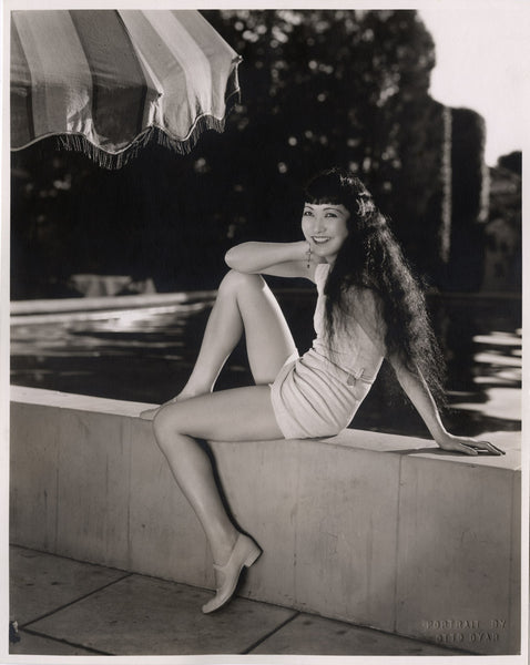 Actor Anna May Wong posing poolside