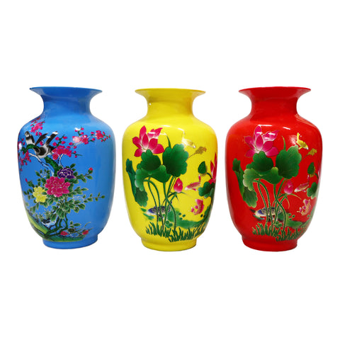 Blue, yellow, and red vases with floral design