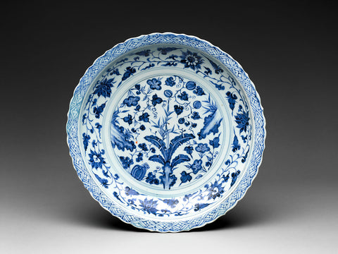 Blue and white plate with flowers, fruit, and rocks
