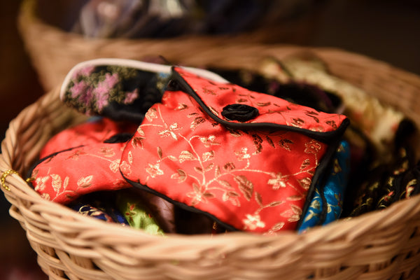 Pretty brocade jewelry bags in a basket