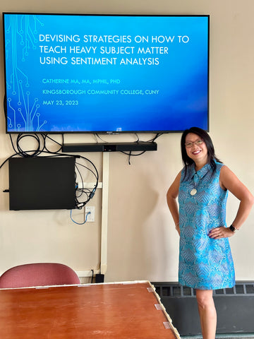 Dr. Catherine Ma in blue dress giving presentation