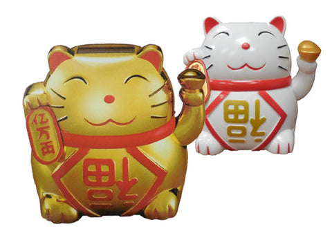 Two lucky cat figurines, one gold, one white