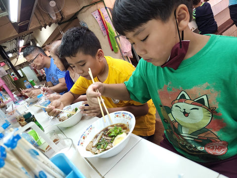 Boys enjoy Hokkein noodles