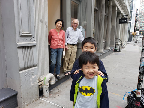 Two kids with grandparents in the background