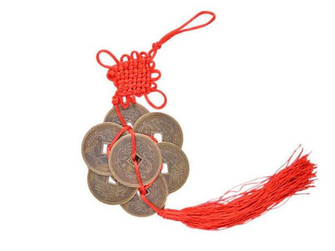 A lucky coin ornament with red tassels