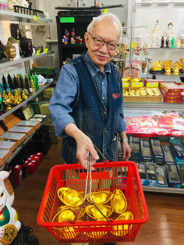 Mr. Chen with basket full of gold ingots