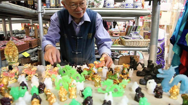 Mr. Chen arranging Buddha figurines