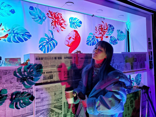 Melissa Ip poses in front of her likeness at the newsstand lantern by Prisca Choe