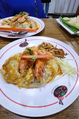 Two dishes of pad thai