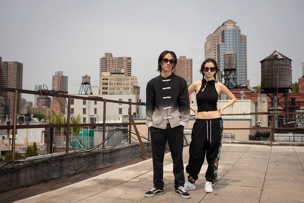 Male and female models in sunglasses on rooftop