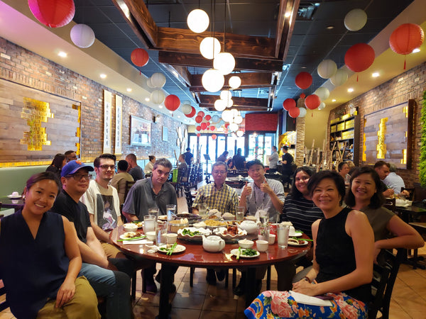 The Pearl River Mart staff at Uncle Lou's restaurant with Pearl River Mart lanterns hanging above