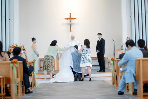 Bride and groom kneel in the church