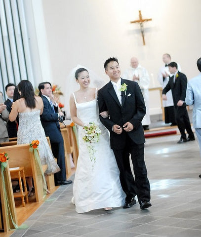 Bride and groom walk down in the aisle in church