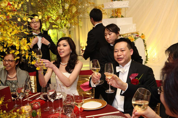 A bride and groom toast their guests