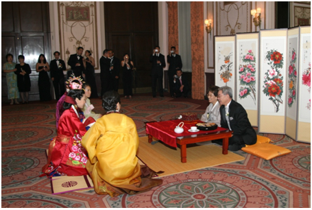 Bride and groom honor groom's parents in traditional Korean ceremony