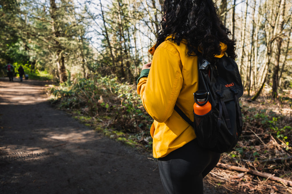 Woman hiking on flat path in woods