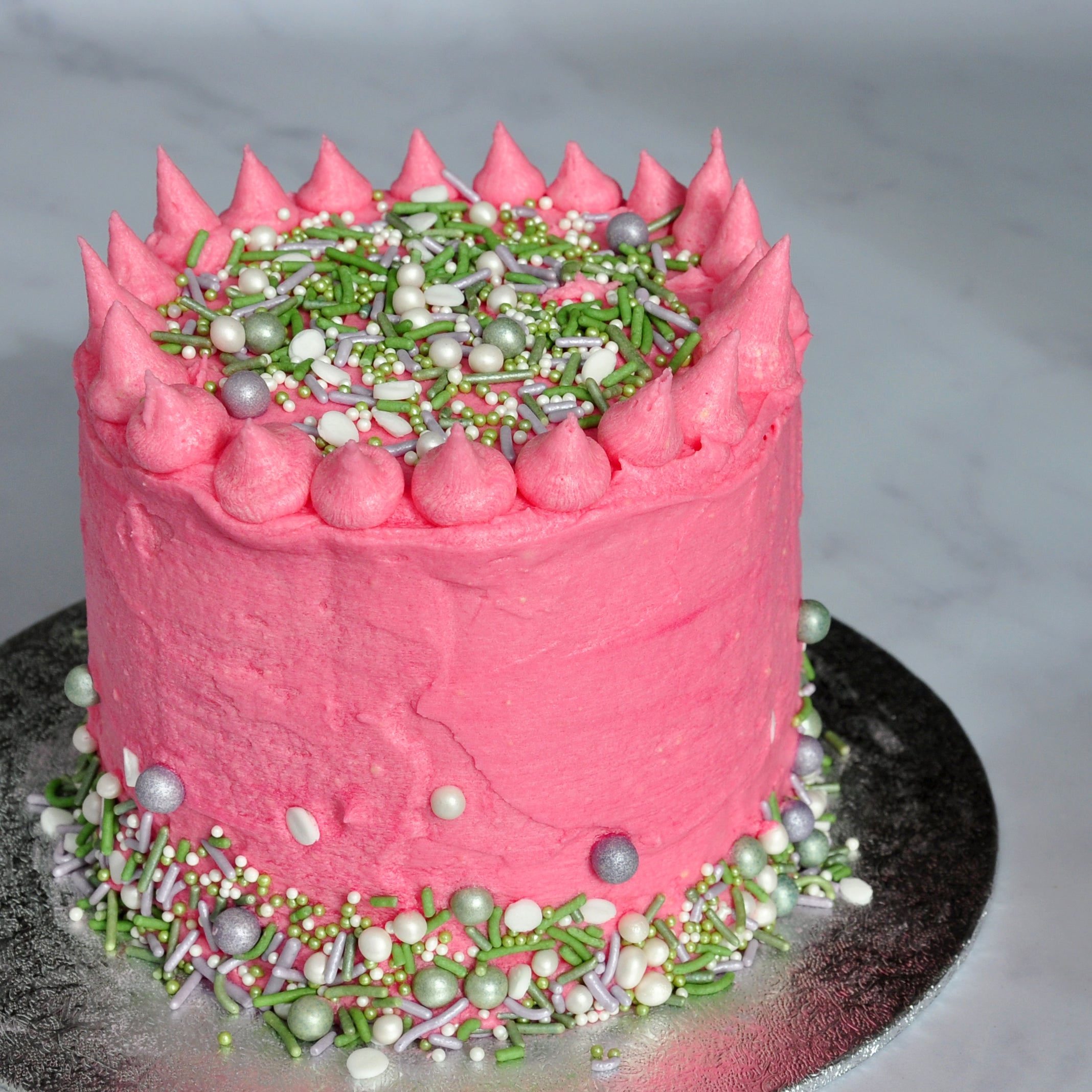 Hope sprinkles on pink vegan layer cake