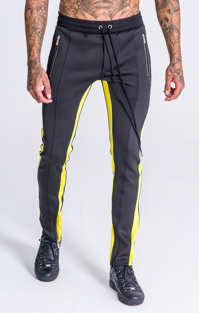 yellow joggers with black stripe