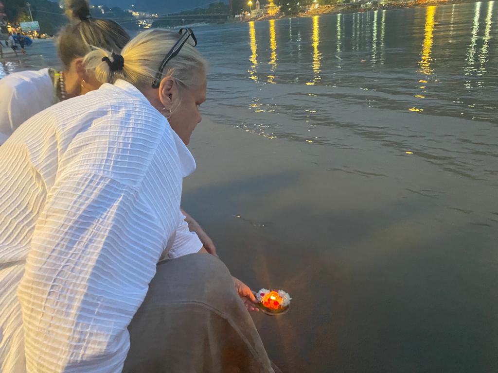 The beautiful ceremony Aarti at Parmarth Ashram where people light candles and float a basket of flowers and incense down the Ganges in memory of loved ones