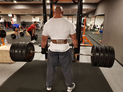 Athlete doing deadlifts with a Gunsmith Fitness weightlifting belt