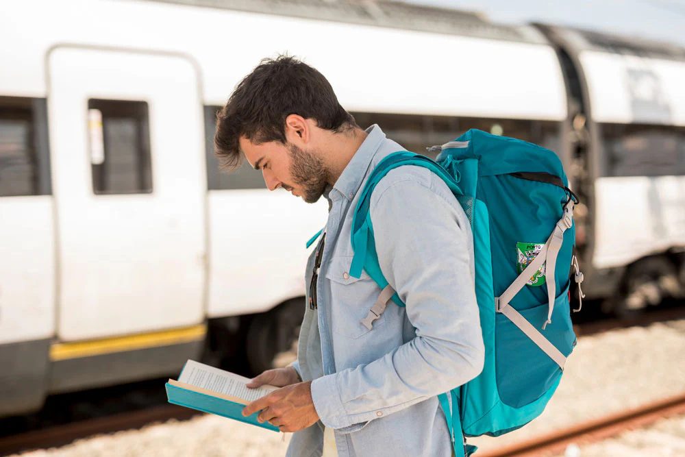 Traveller-in-Merino-wool-clothing-and-jean-shirt-waits-to-board-a-train