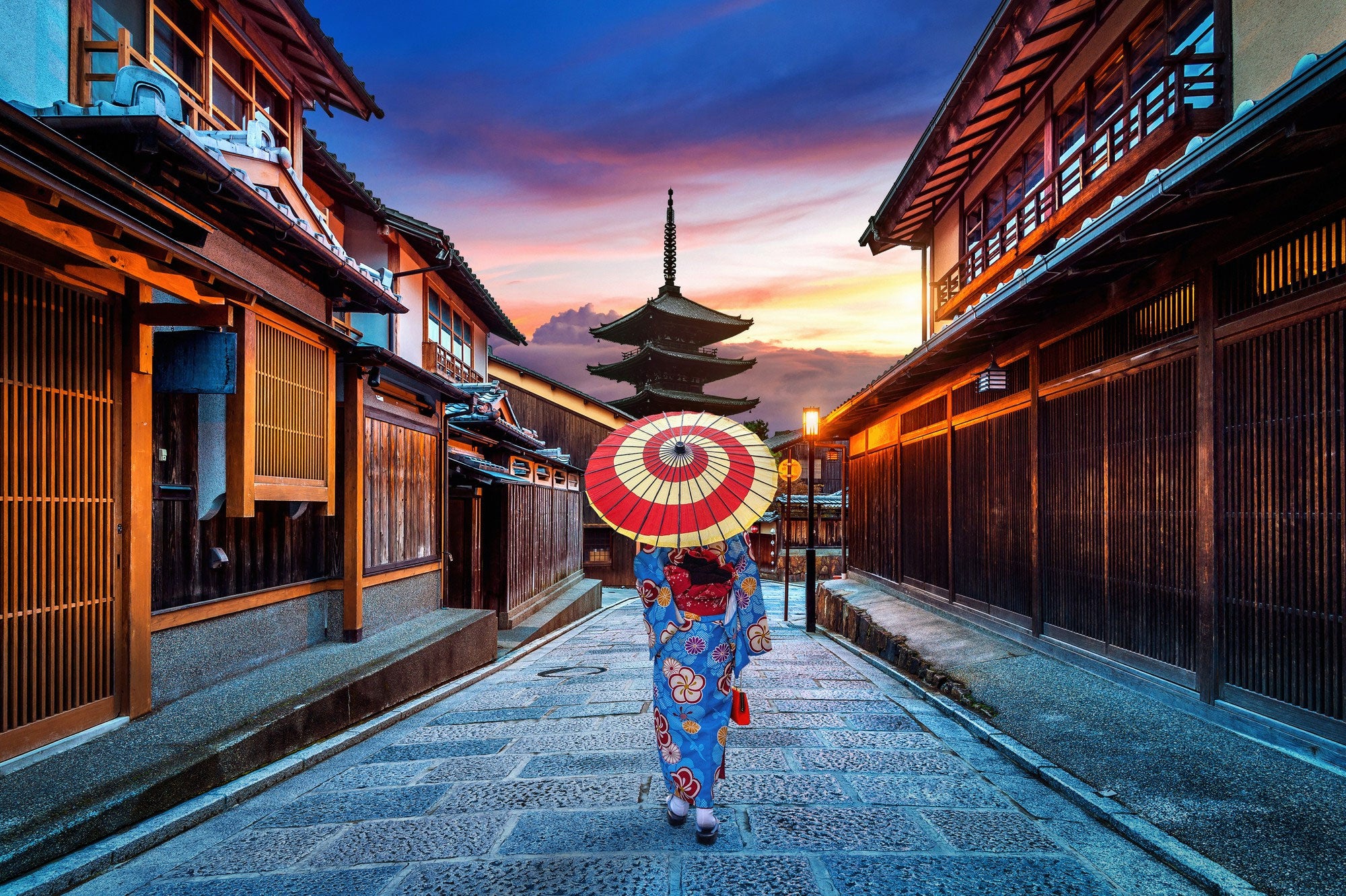 3-A-geisha-walks-down-a-historic-pathway-in-Kyoto