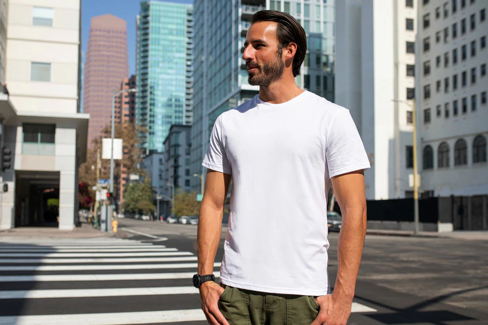 A-man-in-a-white-merino-wool-t-shirt-exploring-a-new-city