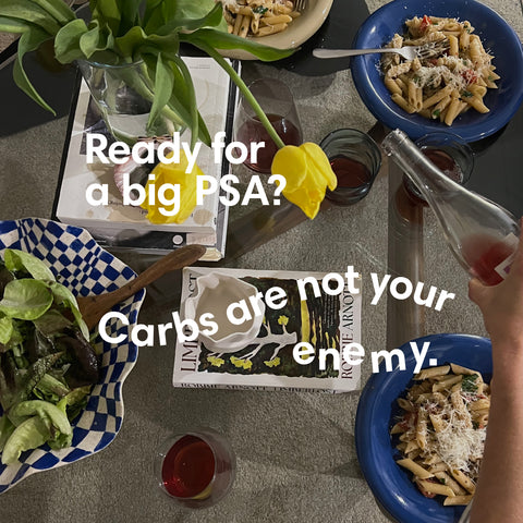 Image of a table with pasta bowls, with the headline: Carbs are not your enemy.