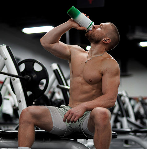 a man at a gym drinking from an Ice Shaker Shaker Bottle