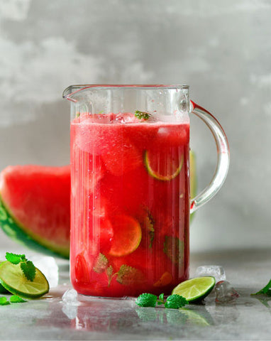 an image of a Watermelon Agua Fresca beverage garnished with a slice of watermelon.