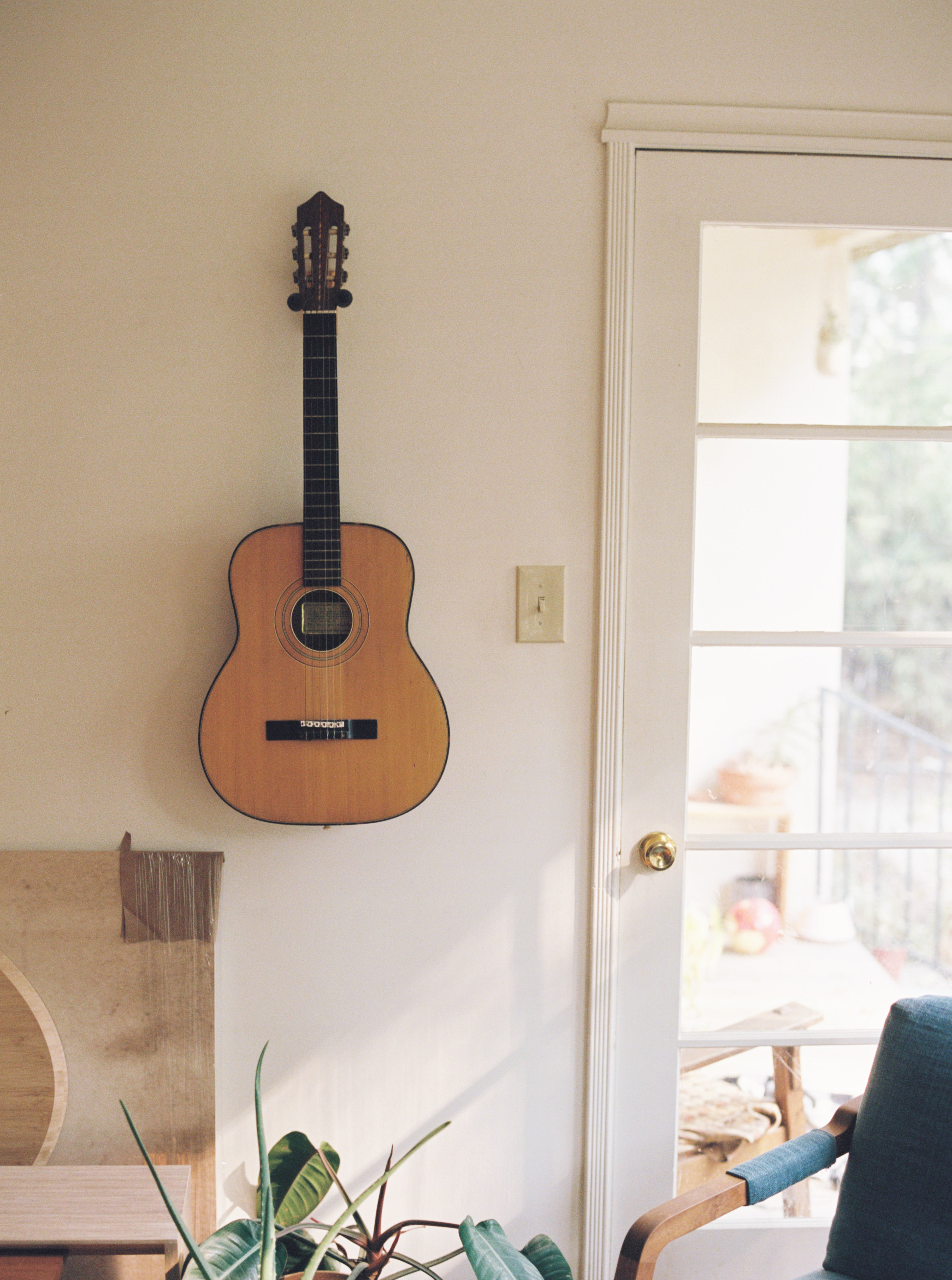 An acoustic guitar hanging in the living room of Bryan Edwards