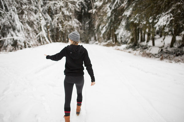 Model wearing black Woolx hoodie in snow