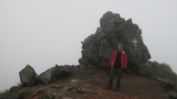 Model standing a top mountain