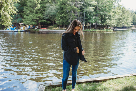 Model wearing shacket next to lake
