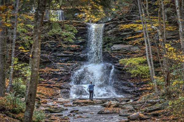 Model standing in front of waterfall