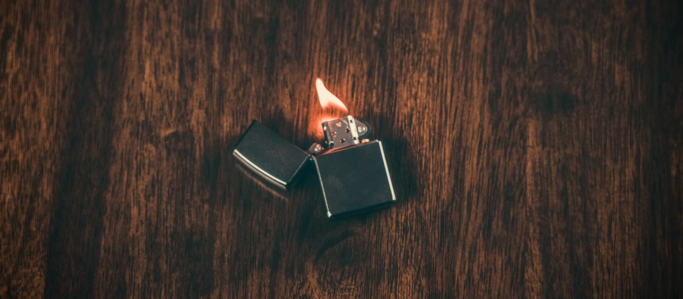 Black Zippo lighter with ignited flame