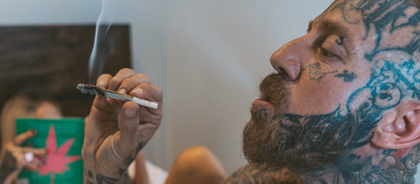 Man smoking pre-rolled cone