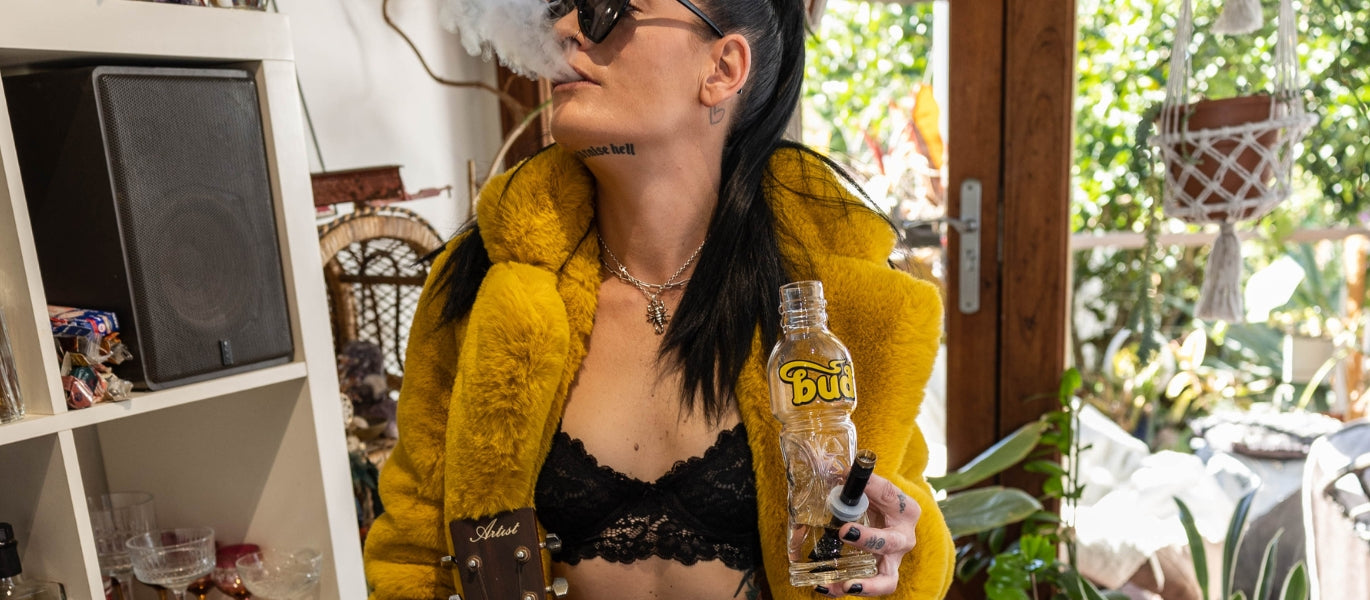 Woman Exhaling Smoke From Bud Bottle Bong